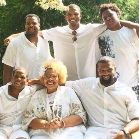 Daniel Bellomy with his mother and brothers.